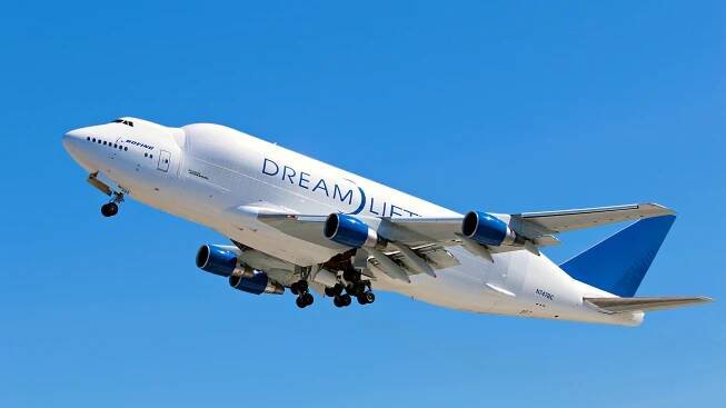 A Boeing 747 Dreamlifter flying in the sky.