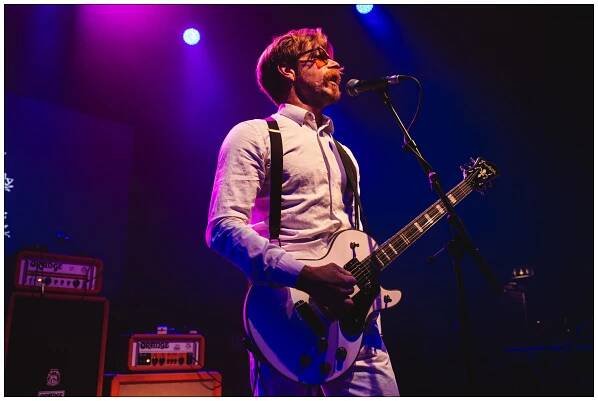 Jesse Hughes of Eagles of Death Metal under purple lights at A Peaceful Noise