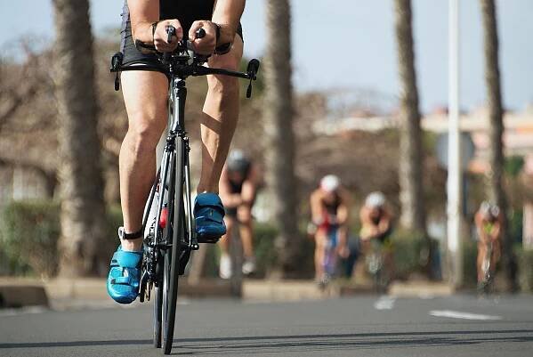 An athlete cycles during an Ironman Triathlon event.