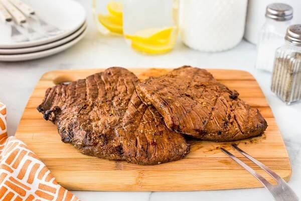 This Grilled Flank Steak done in a quick marinade and grilled over high heat simply melts in your month. It's perfect for a week night meal for the clan or a casual weekend dinner!
