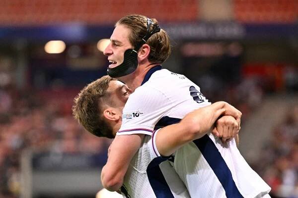 England's James Mcatee celebrates a goal with a teammate.