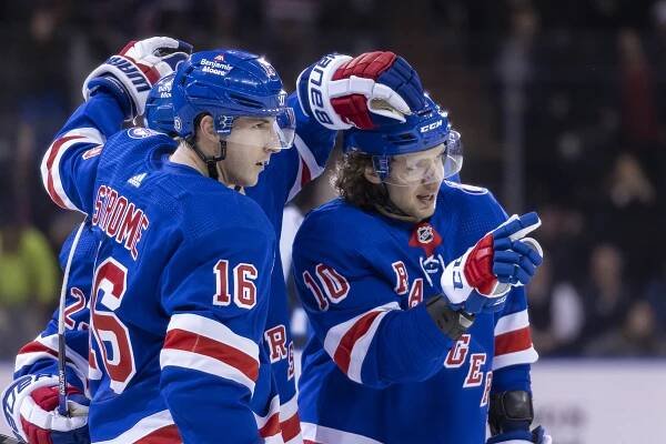 New York Rangers center Ryan Strome (16) and left wing Artemi Panarin (10) celebrate a goal by defenseman Adam Fox in the third period of an NHL Hockey game, Tuesday, April 19, 2022, in New York, NY.