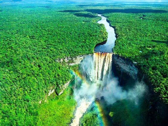 Aerial view of Kaieteur Falls with a rainbow in the Amazon rainforest, Guyana. One of the highest and most powerful waterfalls in the world, surrounded by lush tropical landscape