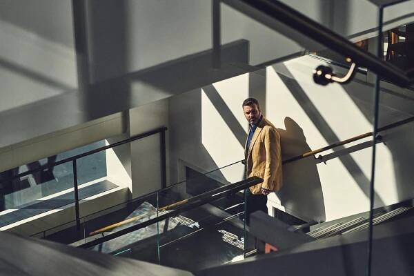 David Carroll looking back as he walks down a stairwell.
