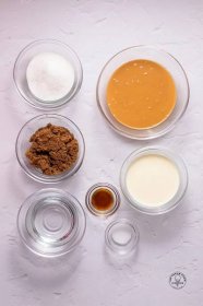 The ingredients needed to make peanut butter ice cream sauce, all in small glass bowls on a counter.