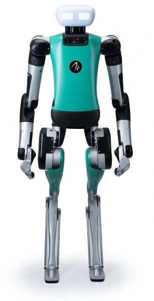 Agility Robotics' humanoid robot Digit. It is mostly team and black, and has a white, rectangular head with large lights for eyes