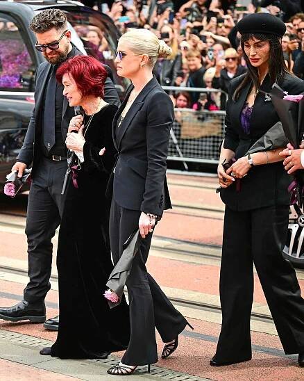 Jack Osbourne, Sharon Osbourne, Kelly Osbourne and Aimee Osbourne view tributes to the late Ozzy Osbourne during his hometown funeral procession 