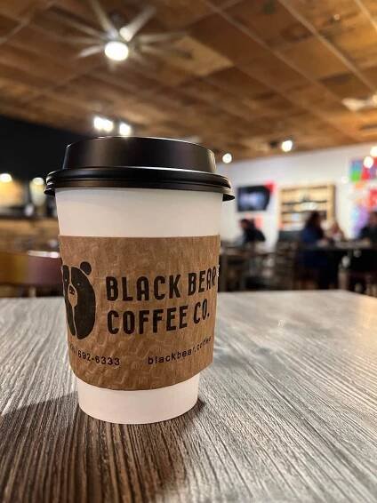 cup of to-go coffee sitting on a table