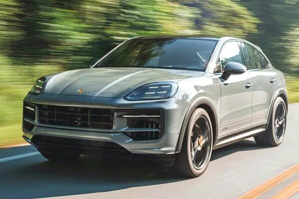 Three-quarter front view of a 2024 gray Porsche Cayenne GTS Coupe
