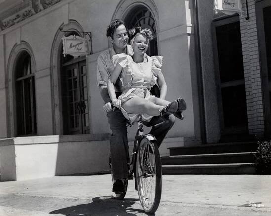 Broderick Crawford and Jane Frazee ride a bike.