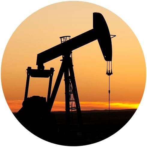 silhouette of oil pump against sunset sky