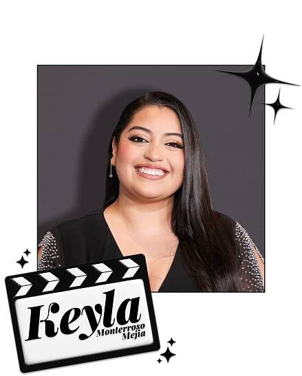Keyla Monterroso Mejia smiles in front of a gray wall