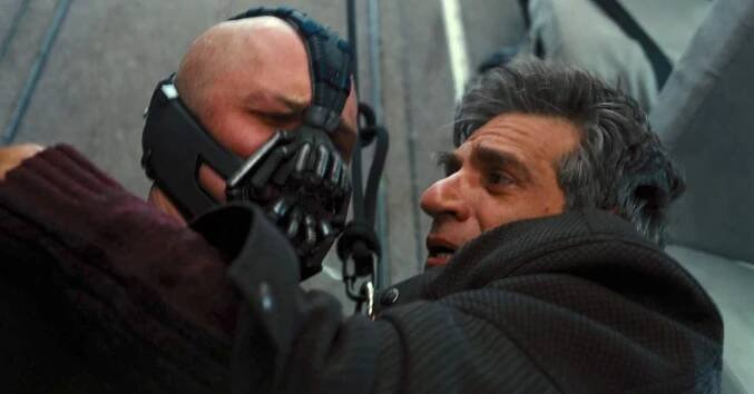 Tom Hardy as Bane, Alon Aboutboul as Dr. Leonid Pavel in "The Dark Knight Rises"