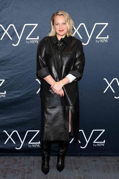 Elisabeth Moss Soft Smile Holding Wrist Black Leather Shacket and Skirt 