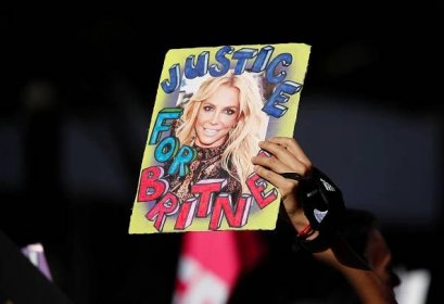 A supporter of singer Britney Spears holds up a picture of the pop star with the words "Justice for Britney