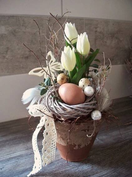 a bird's nest filled with eggs and flowers