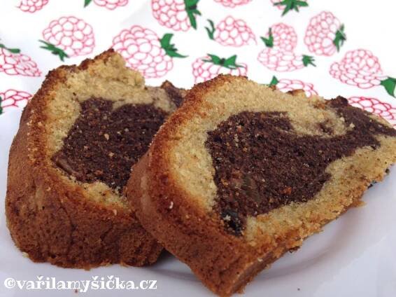 two pieces of chocolate swirl bread on a white plate with red and green flowered cloth