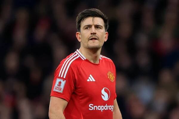 Harry Maguire of Manchester United in a red jersey.