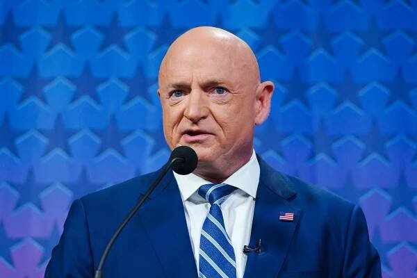 Sen. Mark Kelly prepares to debate fellow U.S. Senate candidates Blake Masters and Marc Victor at the PBS studio in ASU's Walter Cronkite School of Journalism in Phoenix on Oct. 6, 2022.