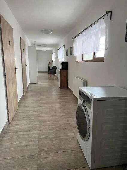 a hallway of a room with a washing machine at Apartmány Nová duha Vavřinec in Vavřinec
