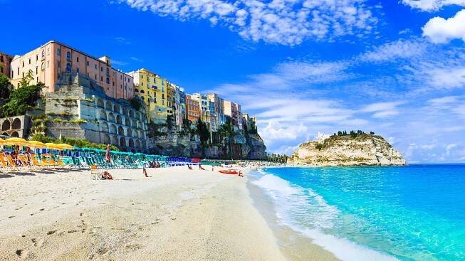 a beach with a large building in the background