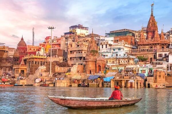 Sunset Over the Ancient Ghats of Varanasi, India, with a Boatman on the Ganges River