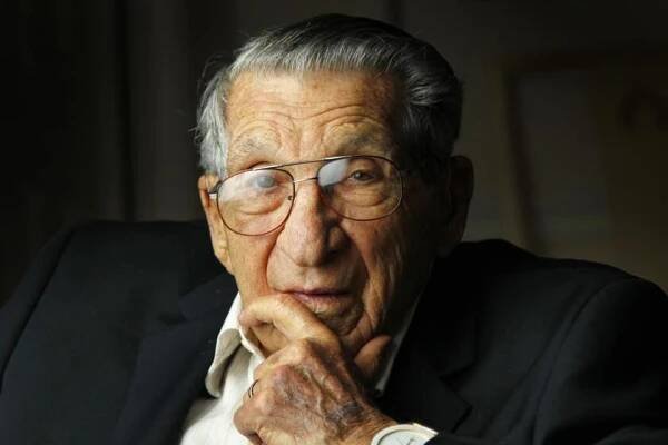 Lester Tenney, shown in 2015, had only eight teeth left when he returned to the U.S. During the death march, a Japanese officer slashed him in the shoulder with a sword. Two other marchers kept him upright while a medic stitched the wound.