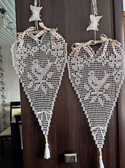 Two White Doily Hanging from the Side of a Door