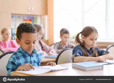 Cute children doing homework in classroom at school 248076172