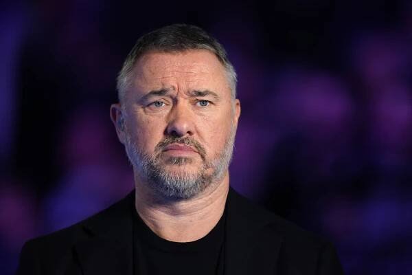 a man with a beard is wearing a black jacket