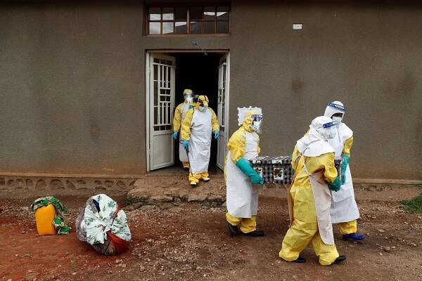 Healthcare workers carry a coffin with a baby, suspected of dying from Ebola, in Beni, North Kivu Province of Democratic Republic of Congo.