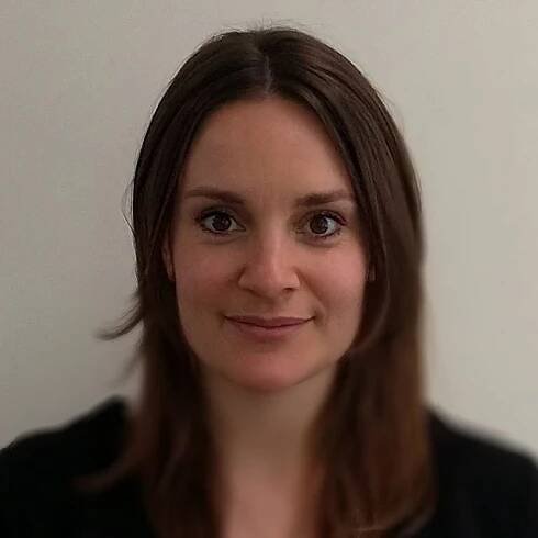 headshot of Emily Wigens against dark white background