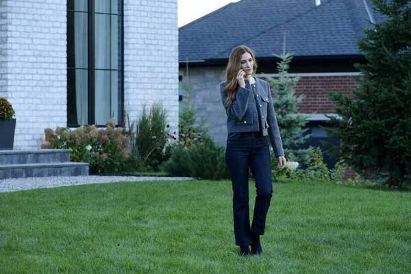 Susan Ireland (Sarah Levy) speaks on the phone on a lawn on SurrealEstate Episode 302.
