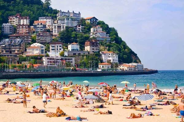 Sunbathers on Ondarreta beach in San Sebastian, Spain