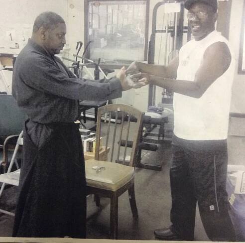Master Joe C. Brown heals a wound with his sword.