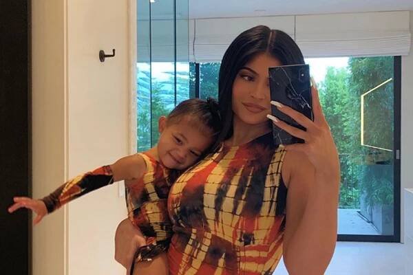 Kylie Jenner and Stormi Webster wearing matching designer dresses.