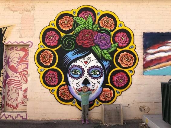 Ada standing in front of mural in downtown Ajo, AZ