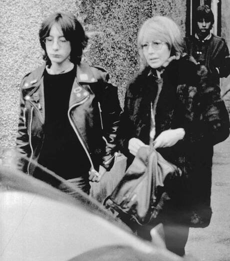 John Lennon's first wife, Cynthia, and their 17-year-old son, Julian, leave their home here Dec. 9