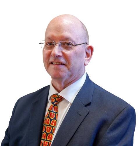 A bald man wearing glasses and a suit and tie