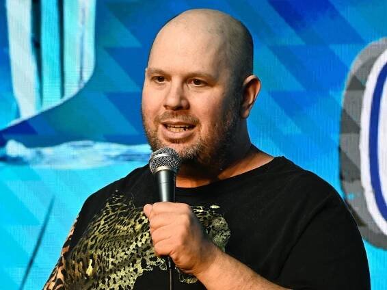Jason Harris performing on stage. 