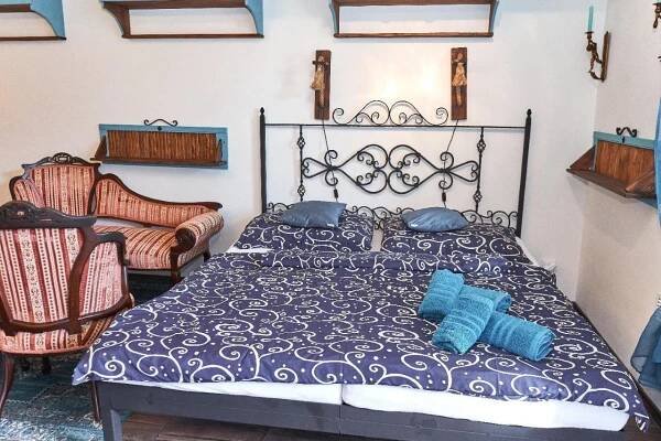 a bedroom with a black and white bed with blue pillows at Apartmán MIKU-LOVE in Mikulov