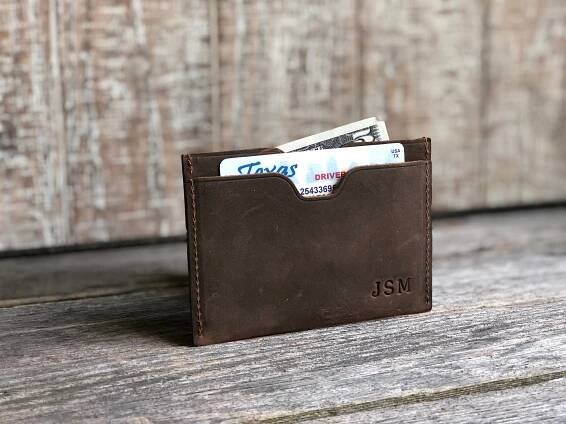 A personalized dark brown leather card wallet.