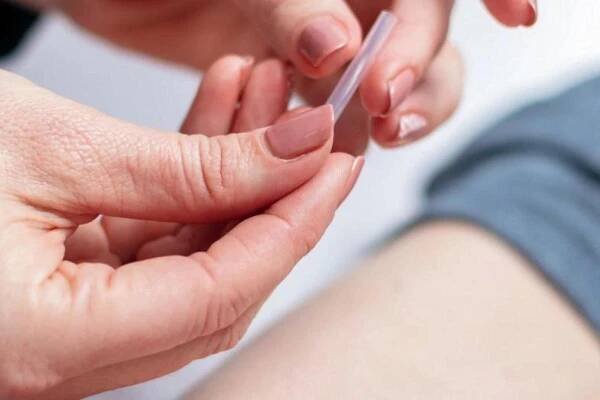 Hand holding a needle in a case