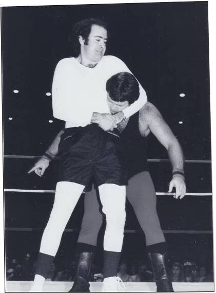 Kaufman putting Lawler in headlock in black and white film photography