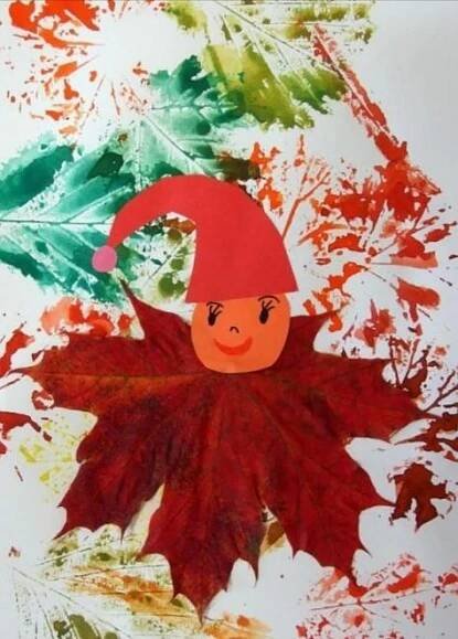 a child's drawing of a leaf with a red hat on it