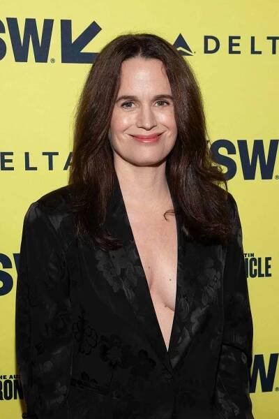 elizabeth reaser in black blazer posing on red carpet
