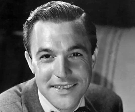 Promotional photograph of actor Gene Kelly in gray suit