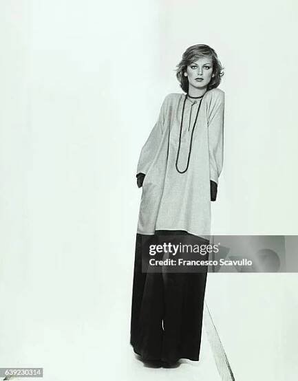 Italian actress Dalila di Lazzaro, leaning against a wall, wearing a one-button cashmere/silk tunic by Geoffrey Beene, over a satin crepe de chine...
