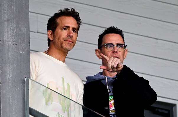 Ryan Reynolds and Colin Hanks at a Wrexham football match.