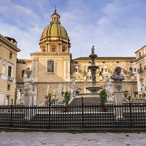 Pretoria Fountain in Piazza Pretoria with the dome of Church of San Giuseppe dei Teatini, Palermo, Sicily, Italy, Europe